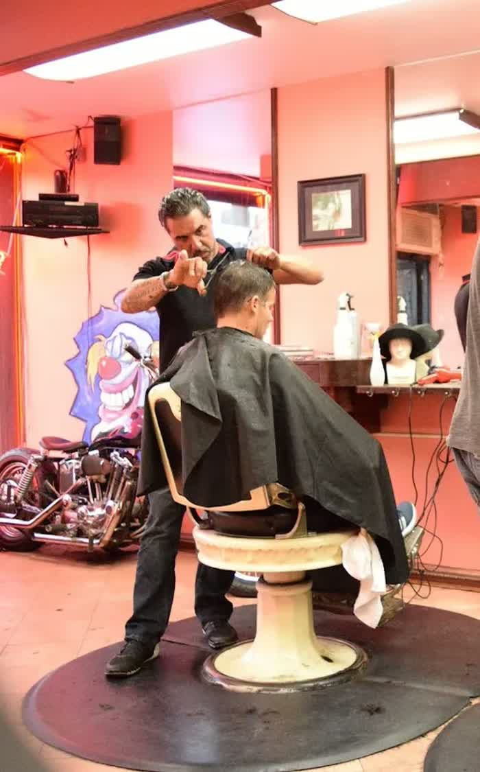 A barber cutting hair at Manny's